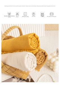 Close-up of cotton linen scarves with fringe edges in woven basket for sun protection