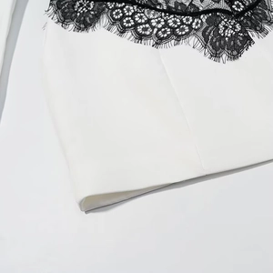 Close-up of elegant black eyelash lace trim on a white dress neckline detail