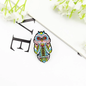 Exquisite colorful owl enamel pin with bohemian floral patterns on a minimal background