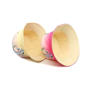 Kids' gradient bucket hats featuring dolphin prints in yellow and pink summer designs
