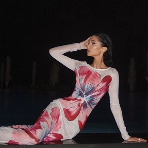 Detailed view of sheer floral mesh fabric and vibrant pink print on a slim fit dress