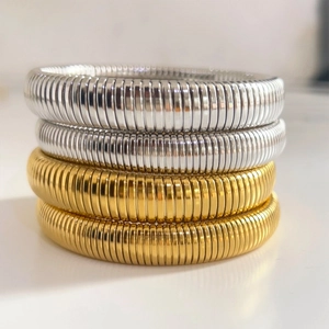 Stack of gold and silver stainless steel textured spring bracelets for men and women