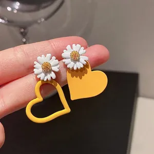 Asymmetric heart and daisy earrings in yellow finish for women with silver needle studs