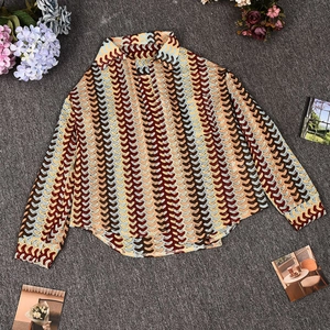 Detailed flat lay of long sleeve shirt featuring retro multi-color wave patterns
