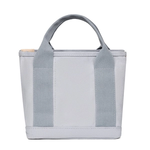 Detailed front view of a grey canvas tote bag with reinforced handles and thick texture