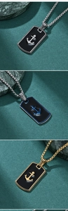 Detail of hip hop anchor pendants in silver, gold, and blue finish with necklaces