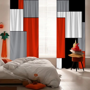 Detail view of modern geometric patchwork curtains with red, grey, and black block patterns
