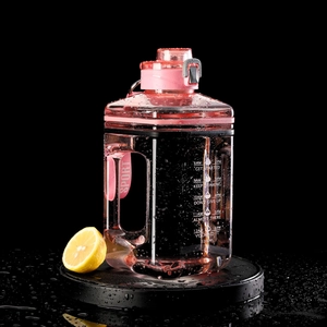 Detail of pink 2200ml square fitness bottle with time markers and side sport handle