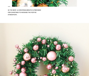 Close-up of pink berries and matte rose gold ornaments on green Christmas wreath