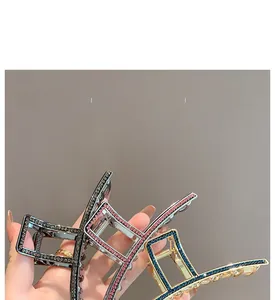 Detailed view of large geometric shark clips with two-tone rhinestones in three colors