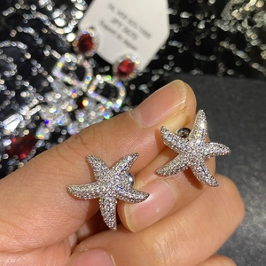 Sparkling S925 silver starfish stud earrings featuring white cubic zirconia accents