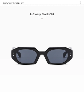 Detail of shiny black polygonal sunglasses with silver rivet accents and grey lenses