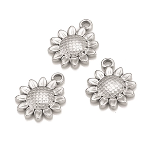 Detailed view of three polished stainless steel sunflower pendants for DIY jewelry making
