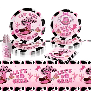 Pink cowgirl themed party tableware set with cow print plates, napkins and disco ball decor