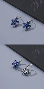 Detail of blue petal flower drop earrings with sparkling crystals and silver lever-back closure