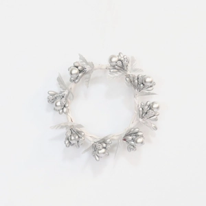 Silver Christmas wreath napkin ring with glitter berries and leaves on white background