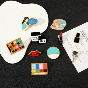 Detailed collection of creative makeup alloy enamel pins on a white decorative tray