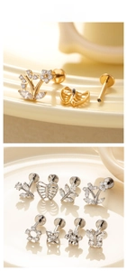 Detailed macro view of titanium labret studs featuring zircon flower and butterfly designs