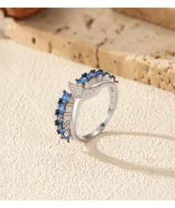 Detailed macro view showing S925 hallmark on silver mermaid tail ring with blue zircon