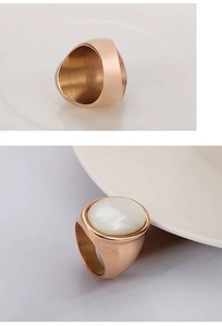 Detail of rose gold stainless steel ring with white shell inlay and brushed inner band