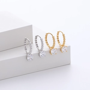 Macro detail of S925 sterling silver hoop earrings with round sparkling zircons
