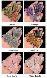 Detail view of six natural crystal butterfly pendants including Amethyst and Rose Quartz