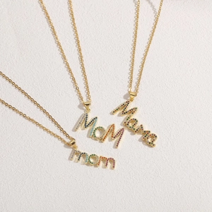 Detailed view of three gold-plated necklaces featuring MOM and Mama pendants with colorful stones