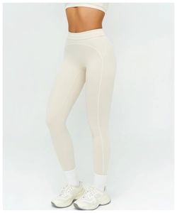 Detail of high waisted yoga leggings with cream matte fabric and white side contrast seams