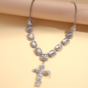 Detailed view of silver cross pendant necklace with geometric resin rhinestones and crystals
