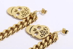 Macro shot of gold-plated skull pendant and chunky chain link with polished finish
