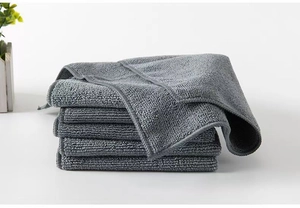 Stack of six grey microfiber cleaning cloths on a white surface for home kitchen use