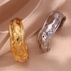 Detail of 18K gold and silver open cuff bracelets with organic hammered texture