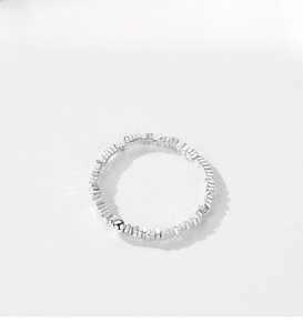 Detailed shot of irregular faceted silver ring featuring a polished bead accent