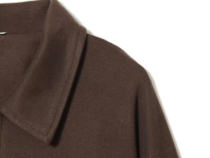 Detailed macro view of the dark brown collar and shoulder texture on this wool bomber jacket