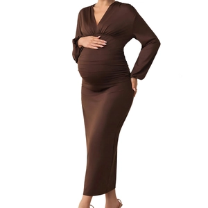 Detail of elegant V-neck maternity dress showing soft ruching and chocolate brown fabric
