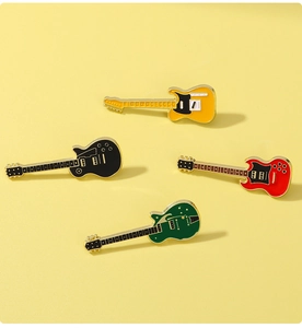 Detailed collection of four colorful guitar enamel pins in yellow black red and green