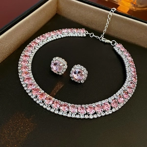Pink round-cut crystal necklace and earrings set showcased in a black jewelry gift box