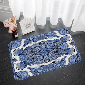 Blue paisley mandala pattern rectangular floor mat on a dark wood floor in home setting