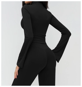 Back view of black slim-fit yoga jacket with flared sleeves and high waist leggings