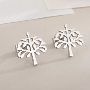 Macro shot of silver cutout Tree of Life stud earrings in polished stainless steel