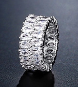 Close-up of a silver wide-band ring featuring micro-pave cubic zirconia crystals