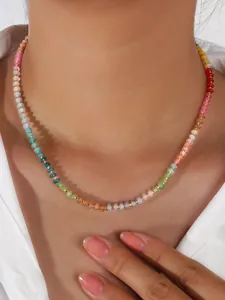 Detail of colorful bohemian beaded necklace with gold spacers and vibrant gradient crystals