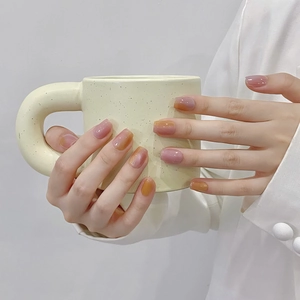 Handcrafted short cat eye press-on nails with amber and pink gradient gloss finish.