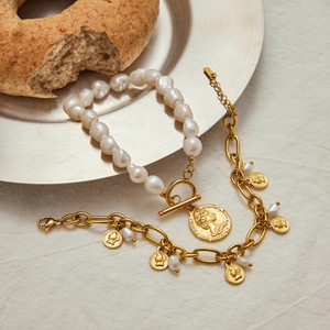 Detail of baroque pearl bracelet with gold coin pendant and vintage Elizabeth II portrait