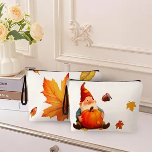 Thanksgiving makeup bag set with maple leaves and gnome prints on white table
