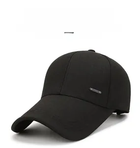 Detail of metal SPORT tag on a black baseball cap with premium four-row brim stitching