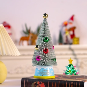 Mini lighted cedar Christmas tree with colorful ornaments and Merry Christmas base