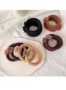 Detail of high-elasticity knitted hair ties with Hand Made leather labels and bear logo