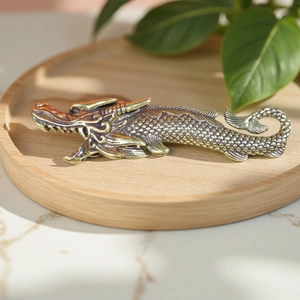 Vintage brass dragon ornament on a wooden tray with a traditional Chinese aesthetic
