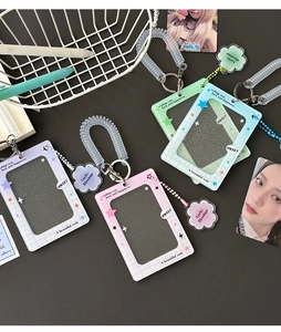 Close-up of four glitter acrylic card holders in purple, pink, green, and blue colors
